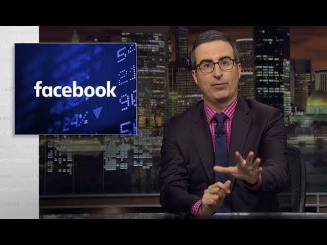 John Oliver at a desk with a Facebook logo appearing to his left.